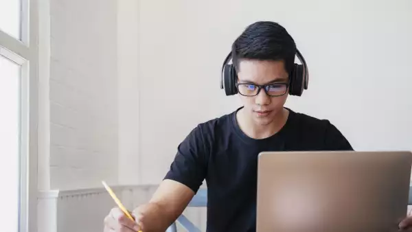 Young man student study at home using laptop and learning online.