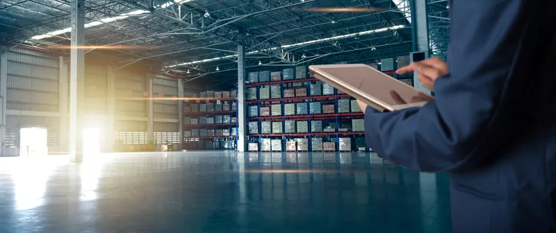 Businessman manager using tablet check and control for workers with Modern Trade warehouse logistics. Industry 5.0 concept