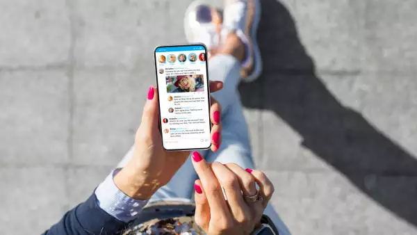 Woman using social media microblogging app on her phone