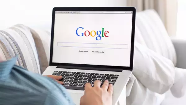 man sitting the MacBook retina with site Google on screen