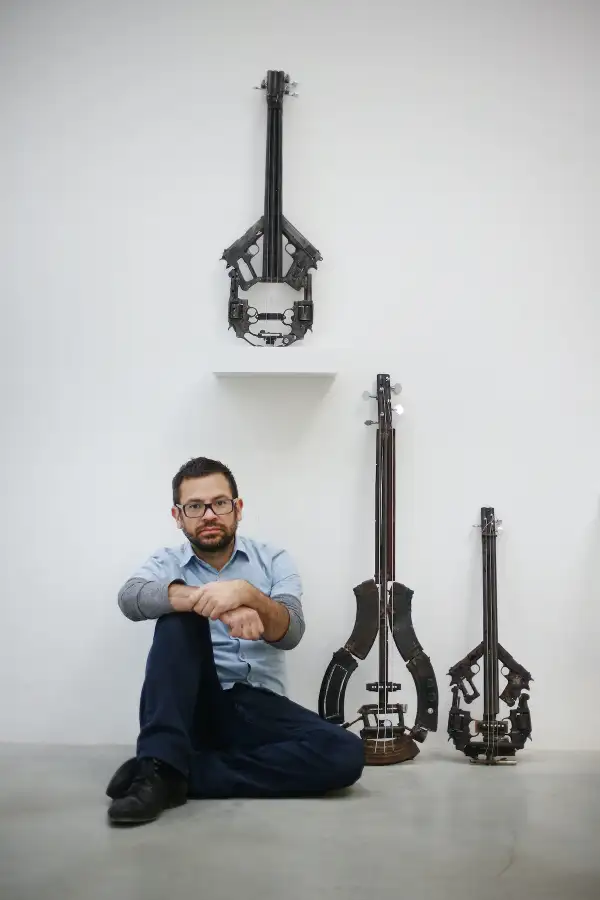 Mexican Artist Pedro Reyes Rehearses Using Musical Instruments He Has Created From Weapons Confiscated From Mexican Cartels