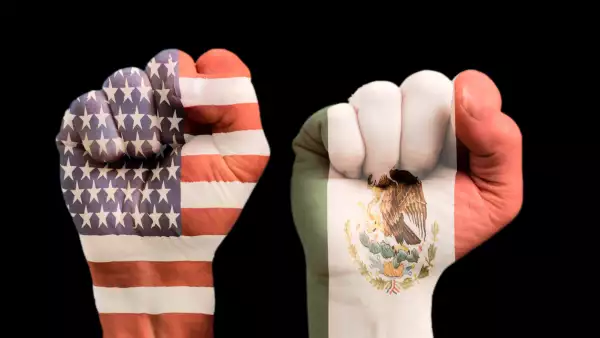 Two fists with embedded American and Mexican flag