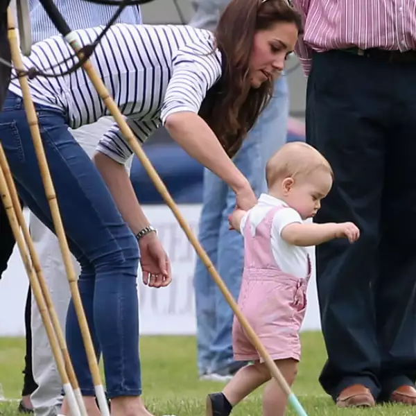 George demostrando sus primero pasos con ayuda de su madre.