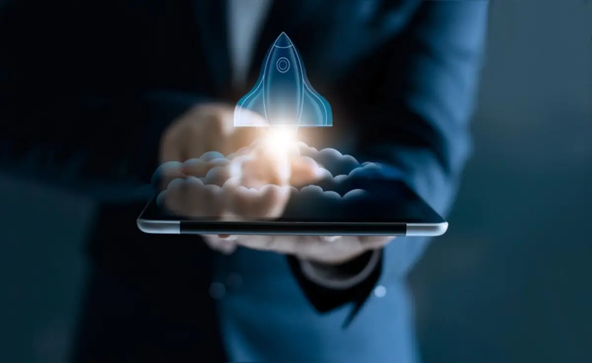 Startup concept, transparent rocket is launching and flying out of tablet on screen
