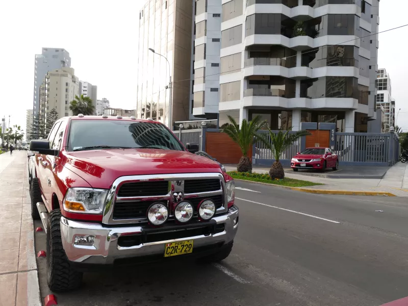 Red color mint condition full size four wheel drive pickup truck Dodge Ram 2500 Heavy Duty parked in Miraflores district of Lima.