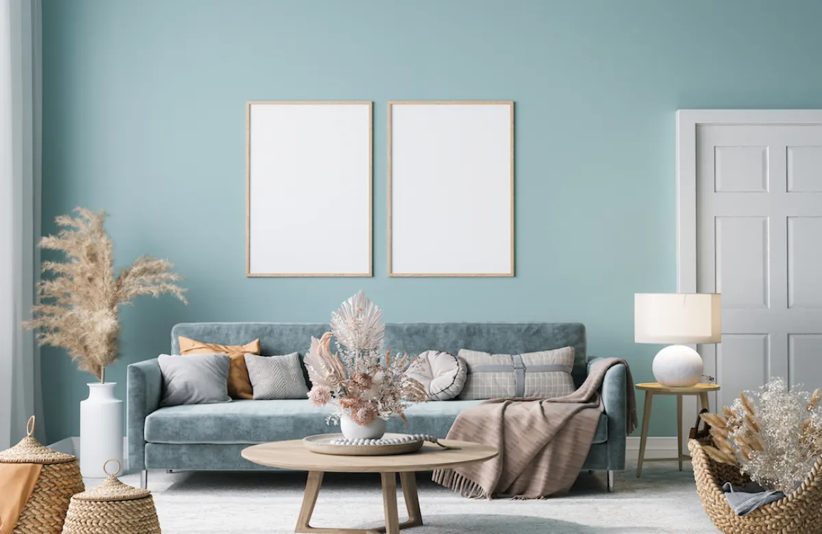 Frame mock-up in home interior with blue sofa, wooden table and decor in blue living room