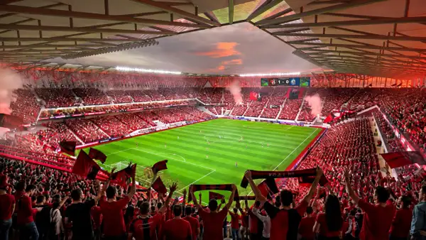 Render del interior del nuevo estadio del Atlas, con la cancha de futbol al centro, tribunas llenas de aficionados rojinegros y cubierta sobre las gradas.