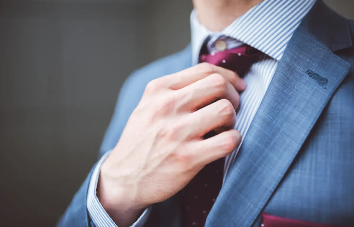 Businessman fixing his tie