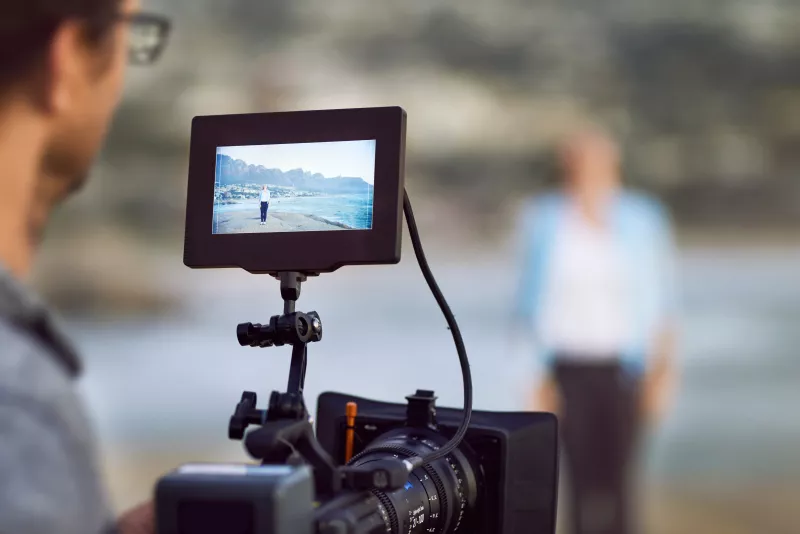 Cropped shot of an unrecognizable man filming outside on his set