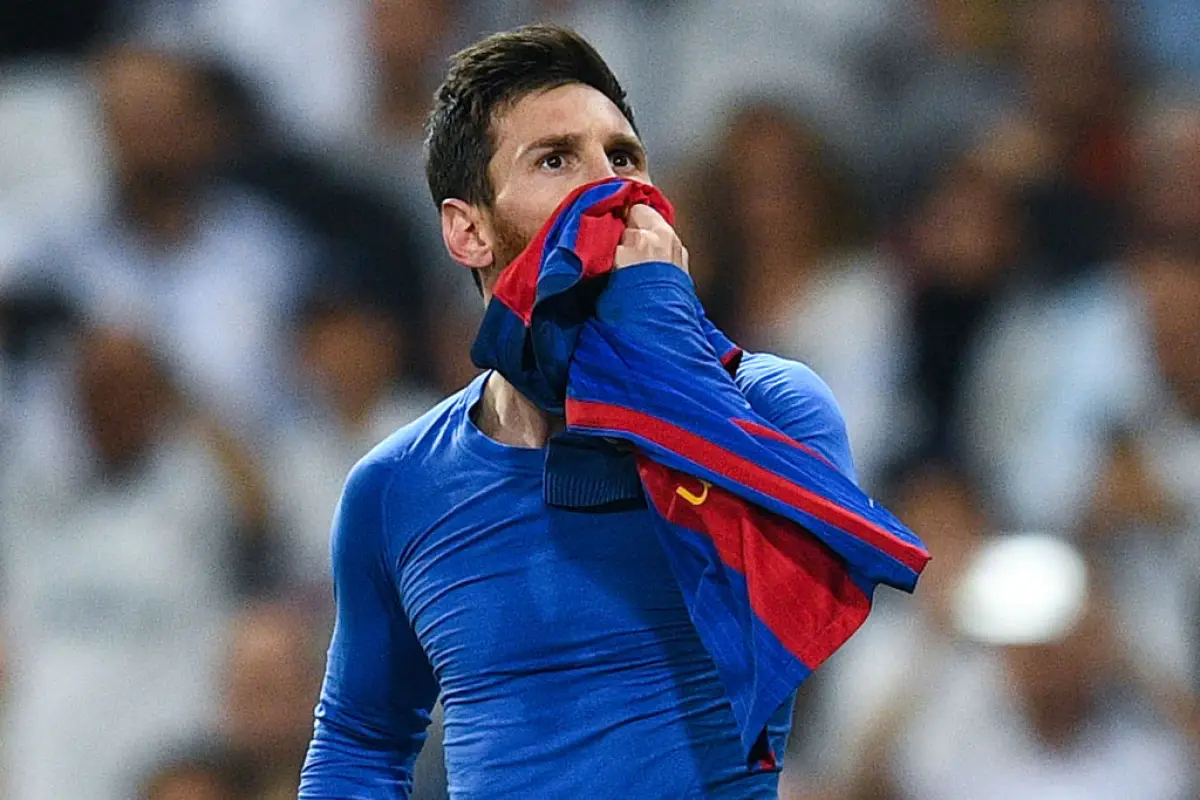Foto de Lionel Messi besando la playera del Barcelona al terminar un partido contra el Real Madrid.
