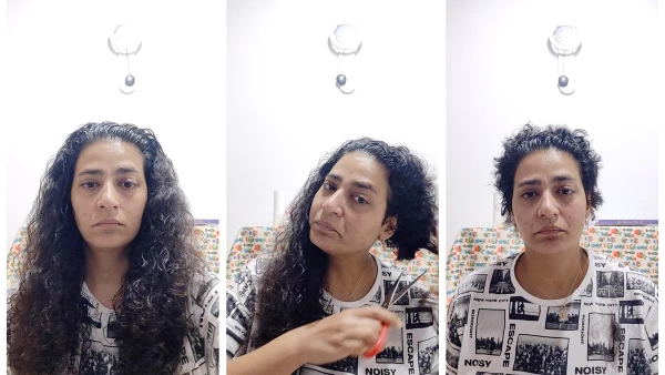 A woman cuts her hair in protest over death of Iranian woman Mahsa Amini in police custody, near Bologna