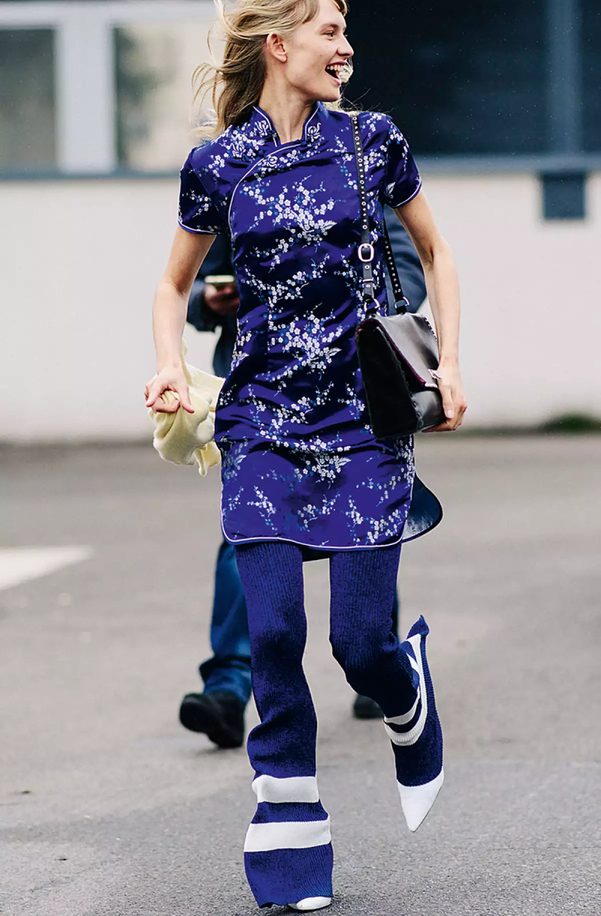 Model wearing blue outfit after a show