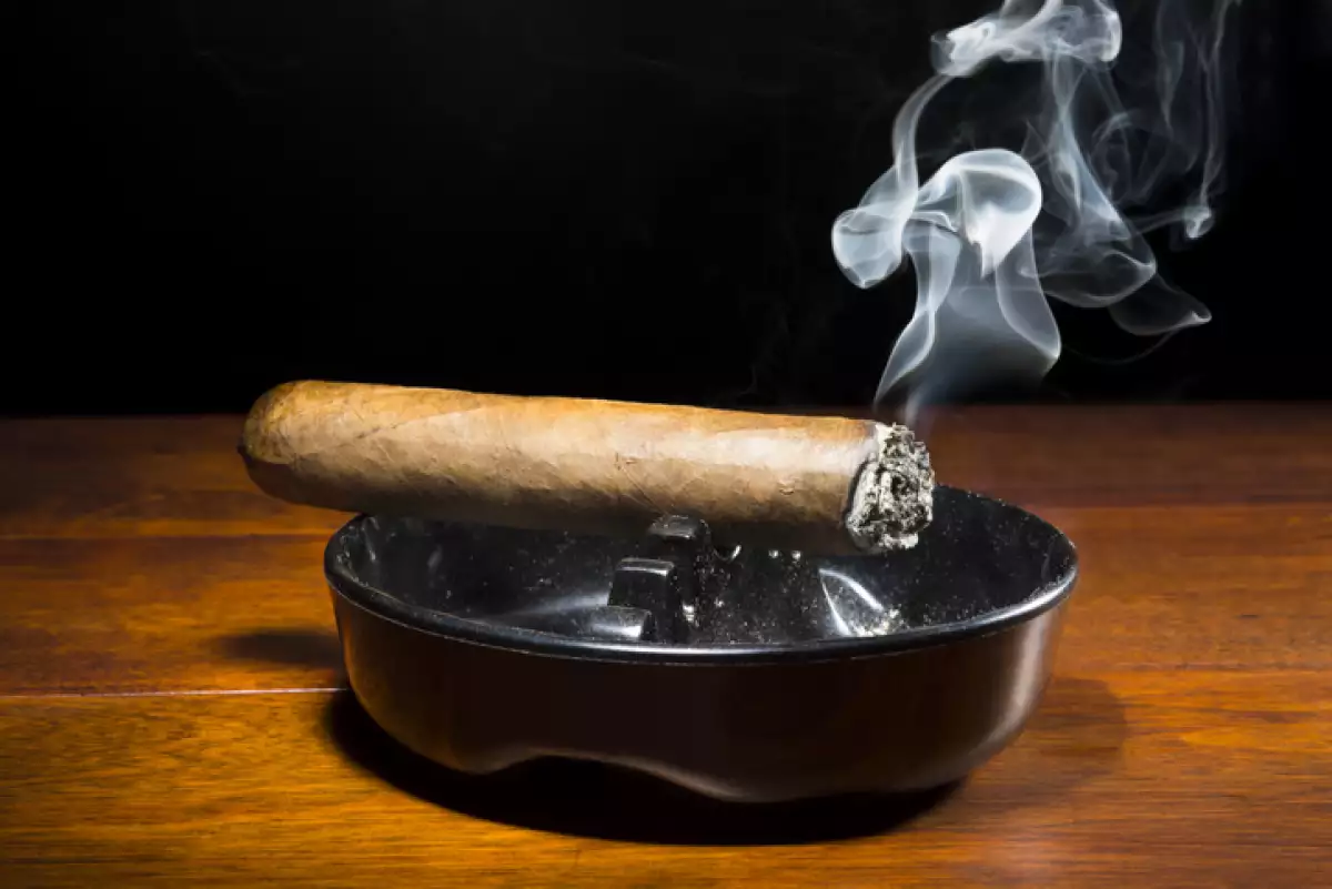 Cigar smoking in ashtray