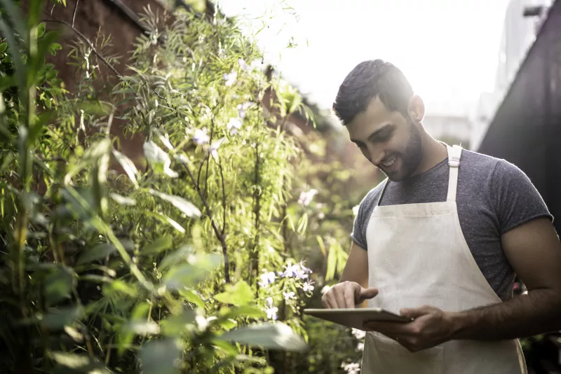 Young florist using a digital tablet