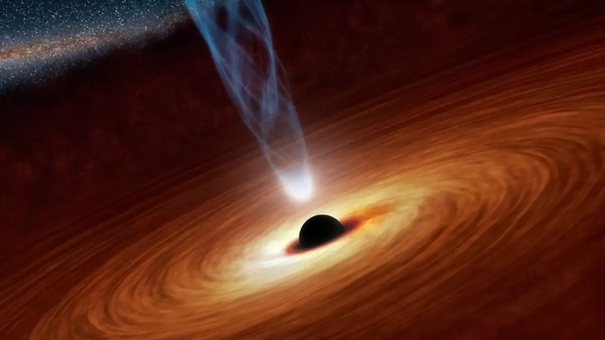 Momento que capturó un telescopio de la NASA en la que se ve a un hoyo negro super masivo emitiendo una luz borrosa y rara