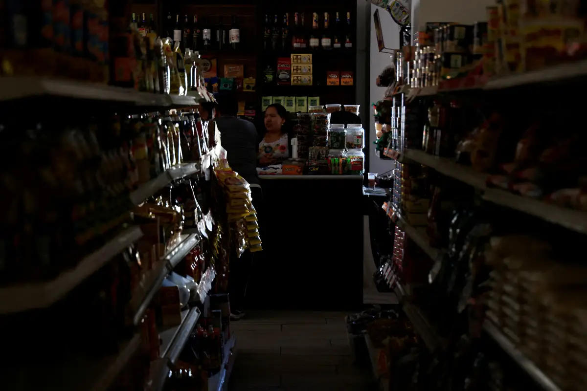 Personas paradas en una tienda durante un corte de energía, en Quito, Ecuador, el 7 de septiembre de 2024.