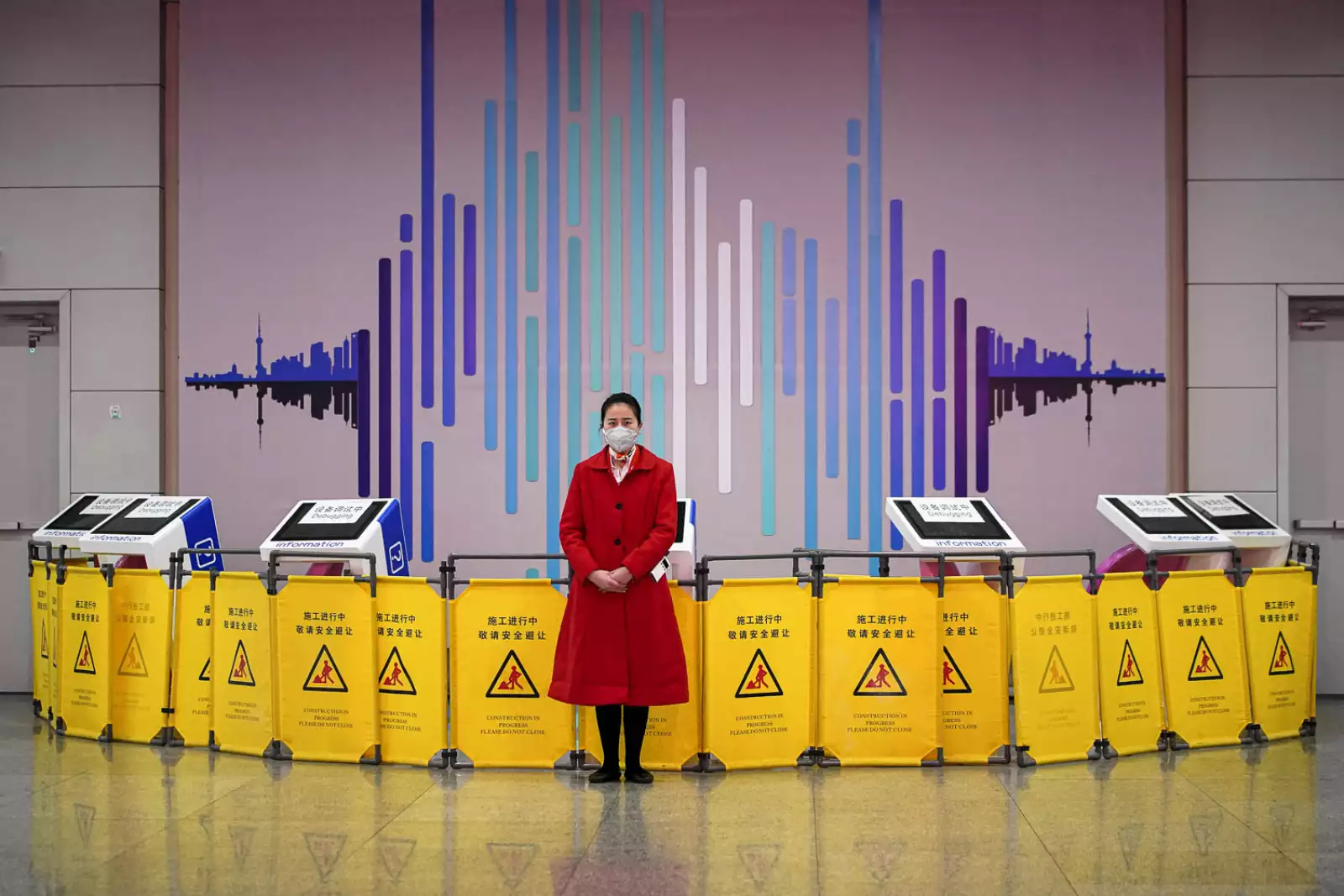 Worker wears a mask at the Pudong International Airport in Shanghai