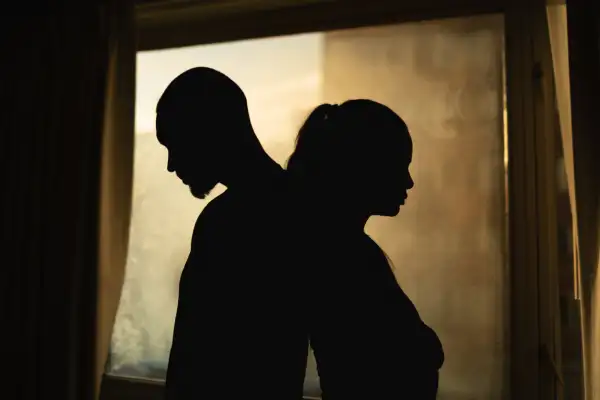 Silhouette of upset  young couple having disagreement, relationship problem, misunderstanding.