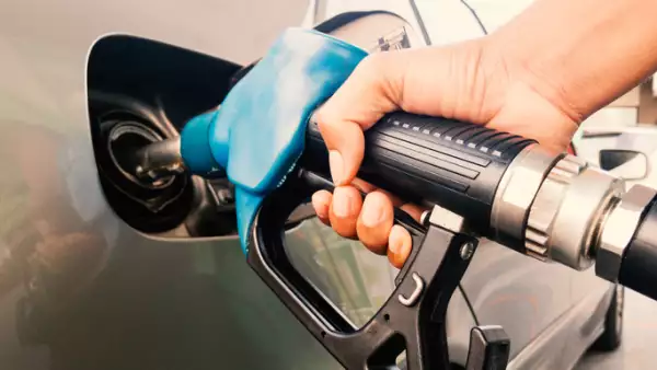 Hand holding gasoline nozzle