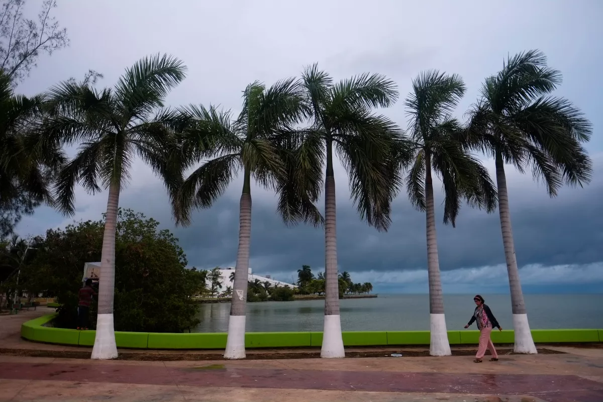 A woman walks along the boardwalk of the bay of Chetumal city, as the state government has declared red alert for proximity of the tropical storm Franklin to the coast of Quintana Roo,