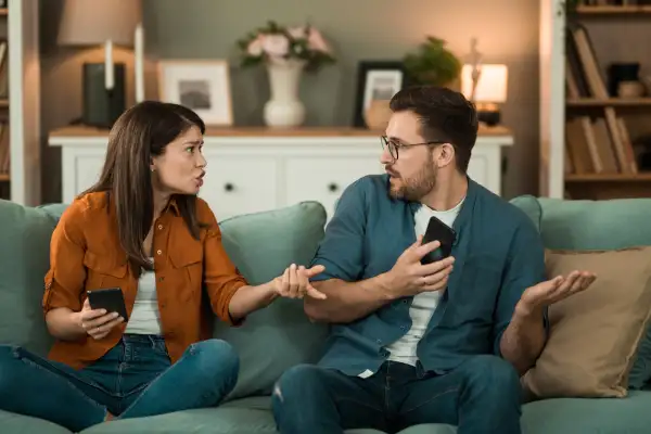 Jealous girlfriend arguing with her boyfriend over text messages.