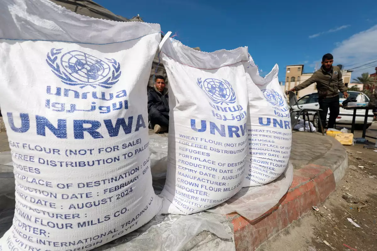 Los palestinos desplazados esperan recibir la ayuda del Organismo de Obras Públicas y Socorro de las Naciones Unidas (UNRWA), en medio del conflicto en curso entre Israel y el grupo islamista palestino Hamas, en Rafah, en el sur de la Franja de Gaza, el 7 de marzo de 2024.