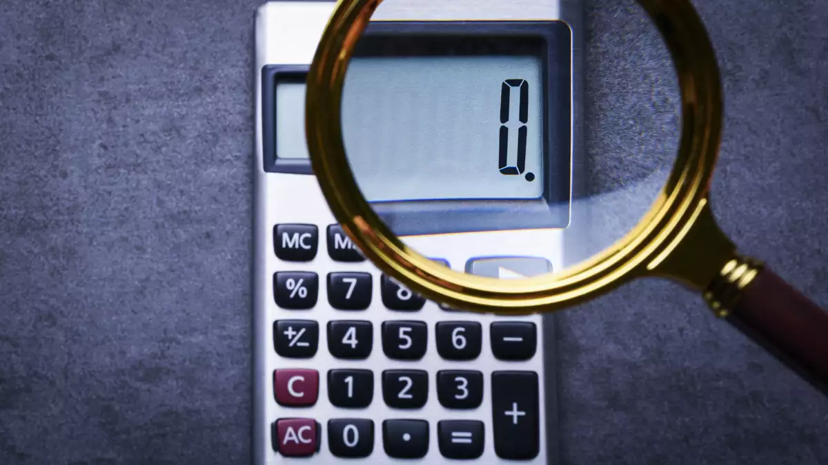 Financal concepts, a calculator showing zero with magnifying glass