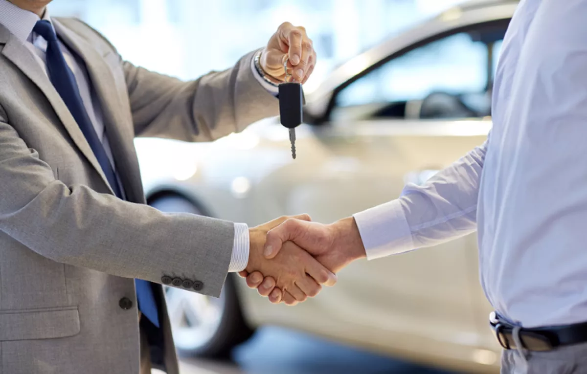 close up of handshake in auto show or salon