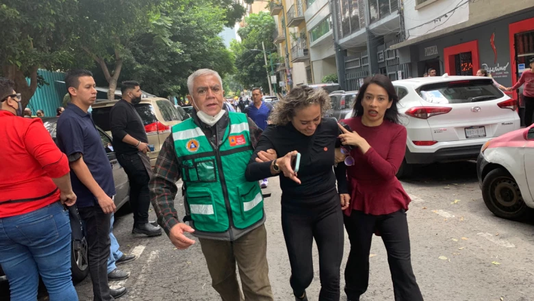 People wait outside their homes after a quake, in Mexico City