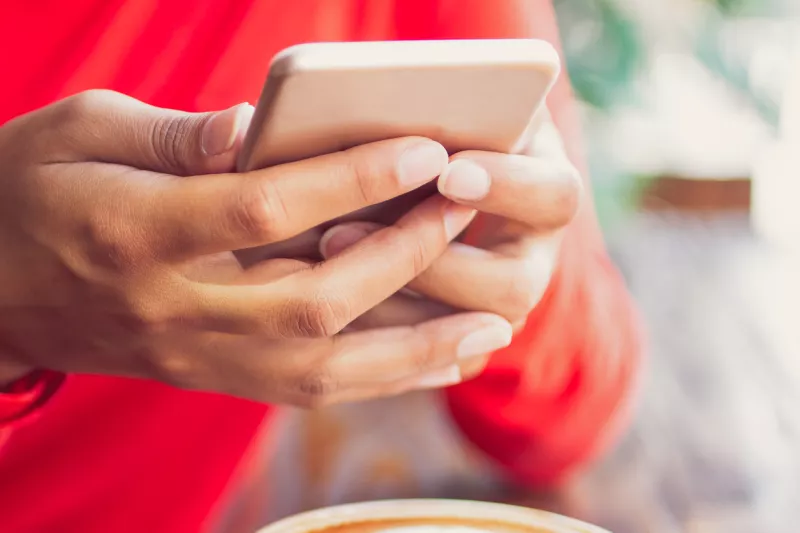 Businesswoman checking message on smartphone
