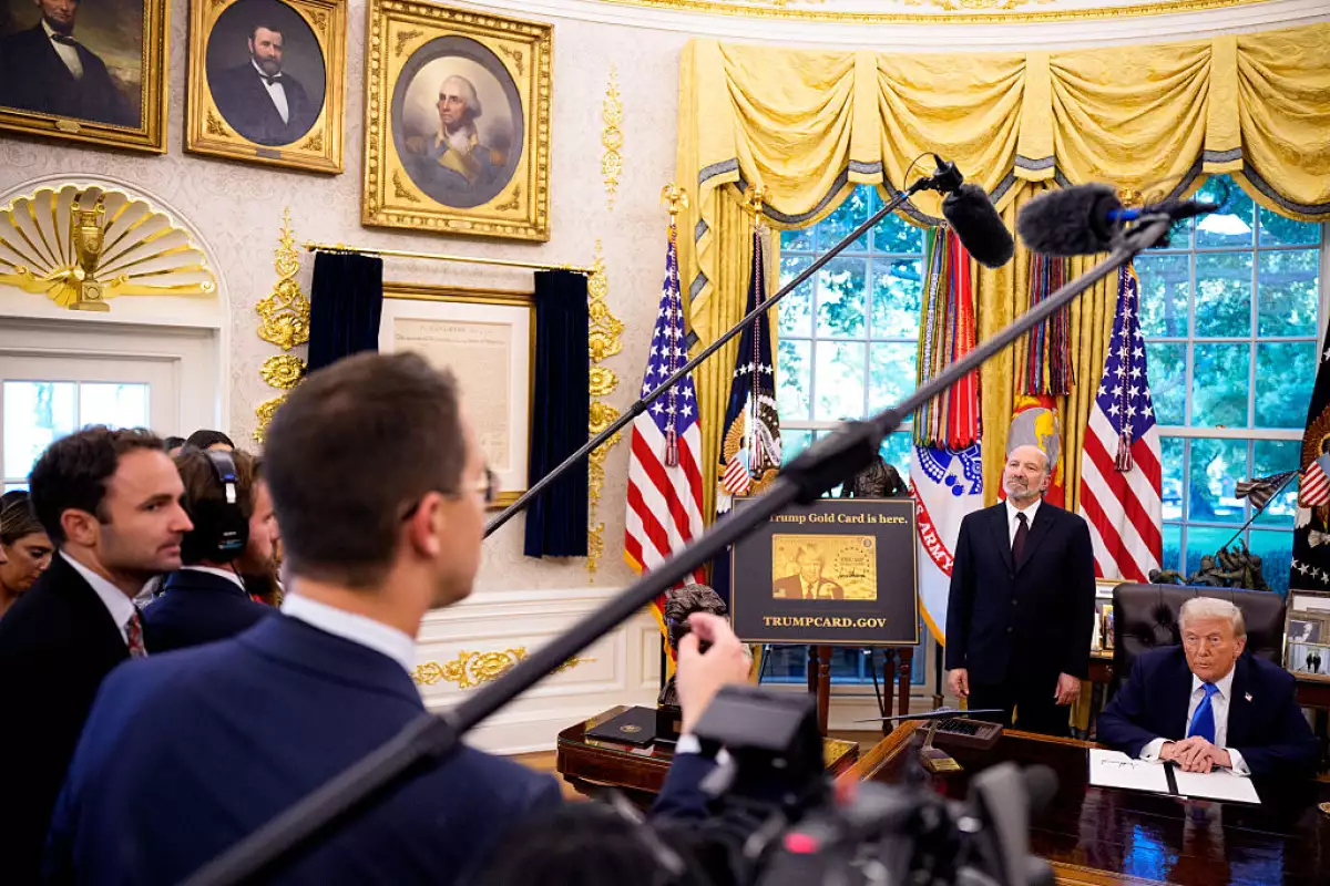 El presidente Donald Trump, acompañado por el Secretario de Comercio de los Estados Unidos, Howard Lutnick (2a R), recibe una pregunta de un reportero después de firmar una orden ejecutiva en la Oficina Oval de la Casa Blanca el 19 de septiembre de 2025 en Washington, DC. Trump firmó dos órdenes ejecutivas, estableciendo la "Trump Gold Card" e introduciendo una tarifa de 100.000 dólares para visas H-1B.
