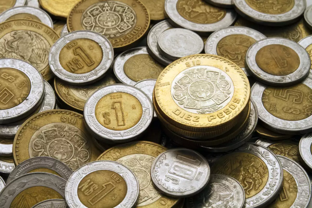 Ten Mexican Pesos Coin on a Pile of Coins