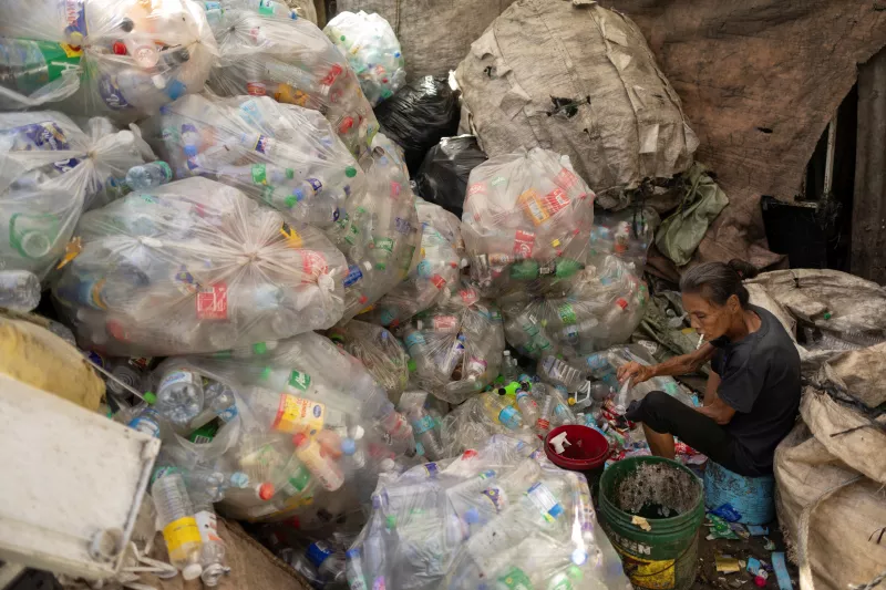 Una mujer clasifica botellas de plástico en una tienda de chatarra en Quezon City, Metro Manila, Filipinas, 27 de noviembre de 2024.