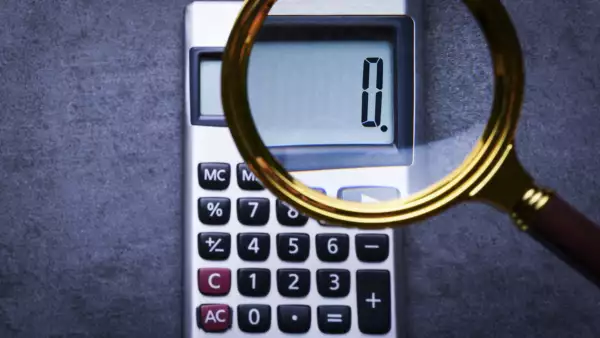 Financal concepts, a calculator showing zero with magnifying glass