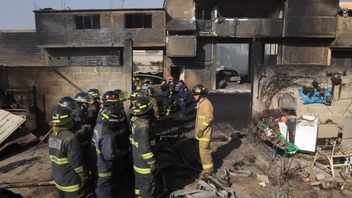 Personal de Protección Civil evacua los cuerpos de personas que perecieron durante una explosión de este domingo