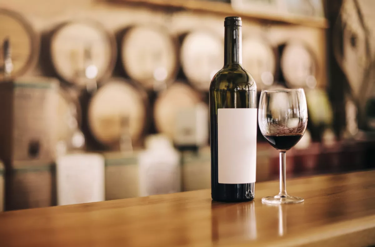 Wine bottle on wooden bar.