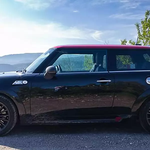 El toldo del vehículo es rojo y causa un efecto contrastante con el negro del resto de la carrocería.