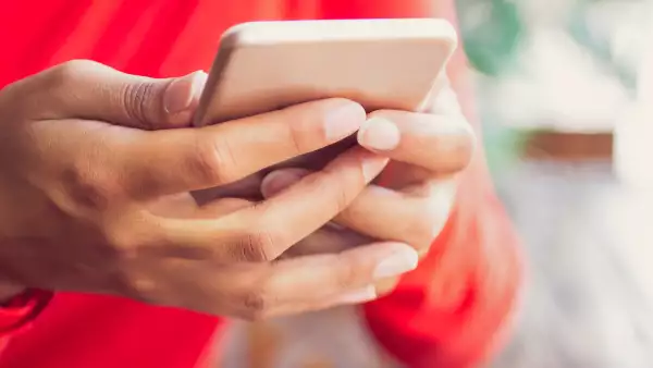 Businesswoman checking message on smartphone