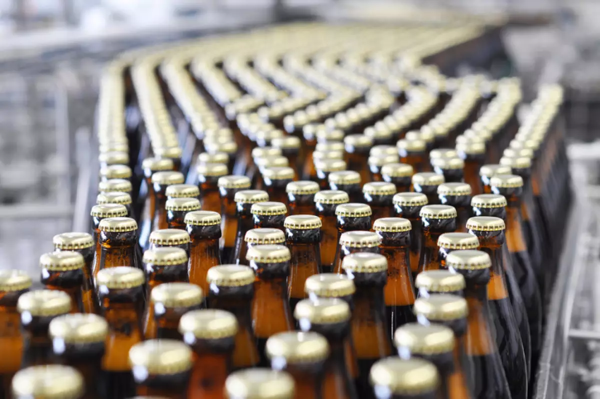 beer filling in a brewery - conveyor belt with glass bottles