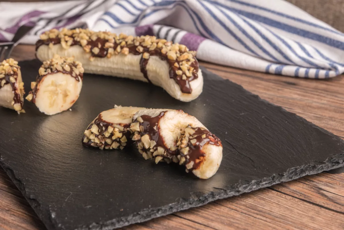 Banana with melted chocolate and nuts 