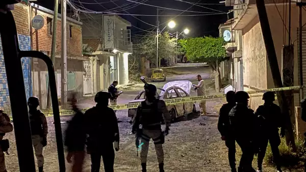 Federal forces keep watch at the scene of an overnight car blast in Celaya