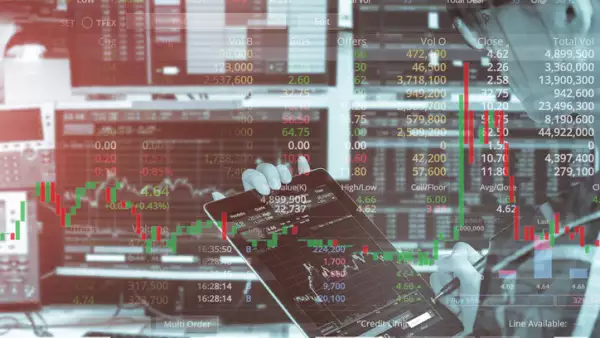 Double exposure of business woman using tablet with stock trading room and stock trading chart background for investment business concept.