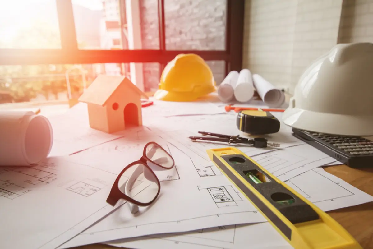 Concept architects, equipment architects On the desk with a blueprint in the office, Vintage, Sunset ligth.Selective Focus