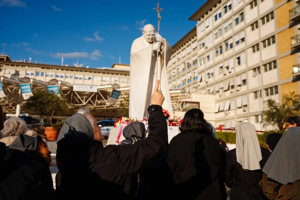 Las monjas rezan en la estatua de Juan Pablo II fuera del Hospital Universitario Gemelli, donde el Papa Francisco está hospitalizado con neumonía, en Roma el 2 de marzo de 2025. El Papa Francisco, que ha estado en el hospital durante más de dos semanas con neumonía doble, se encuentra en un estado "estable" después de pasar una "noche de calma", dijo el Vaticano el 2 de marzo de 2025.